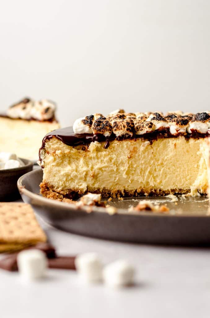 A S'mores cheesecake with several slices taken out of it.