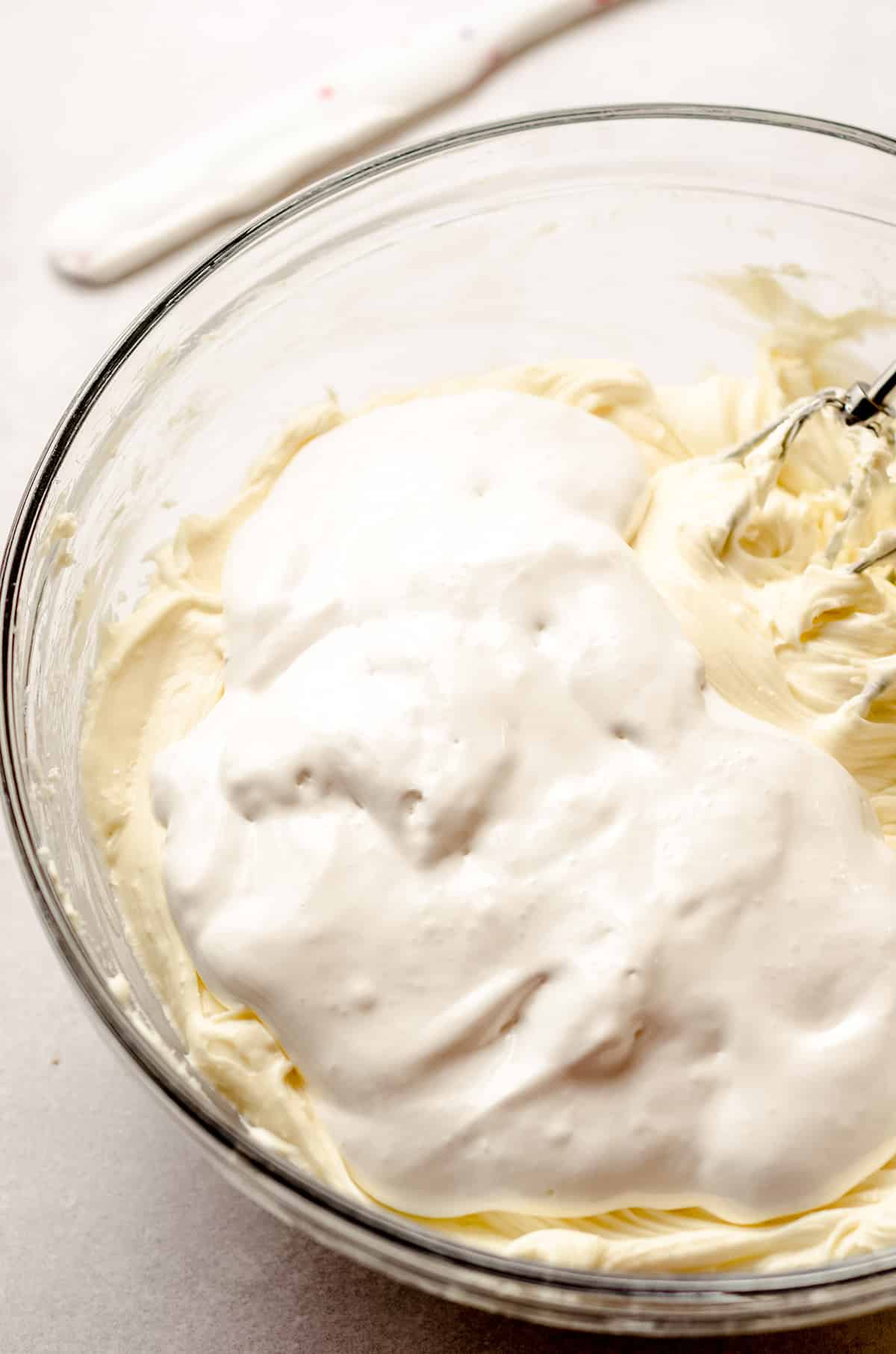 Beating cream cheese and marshmallow creme together.