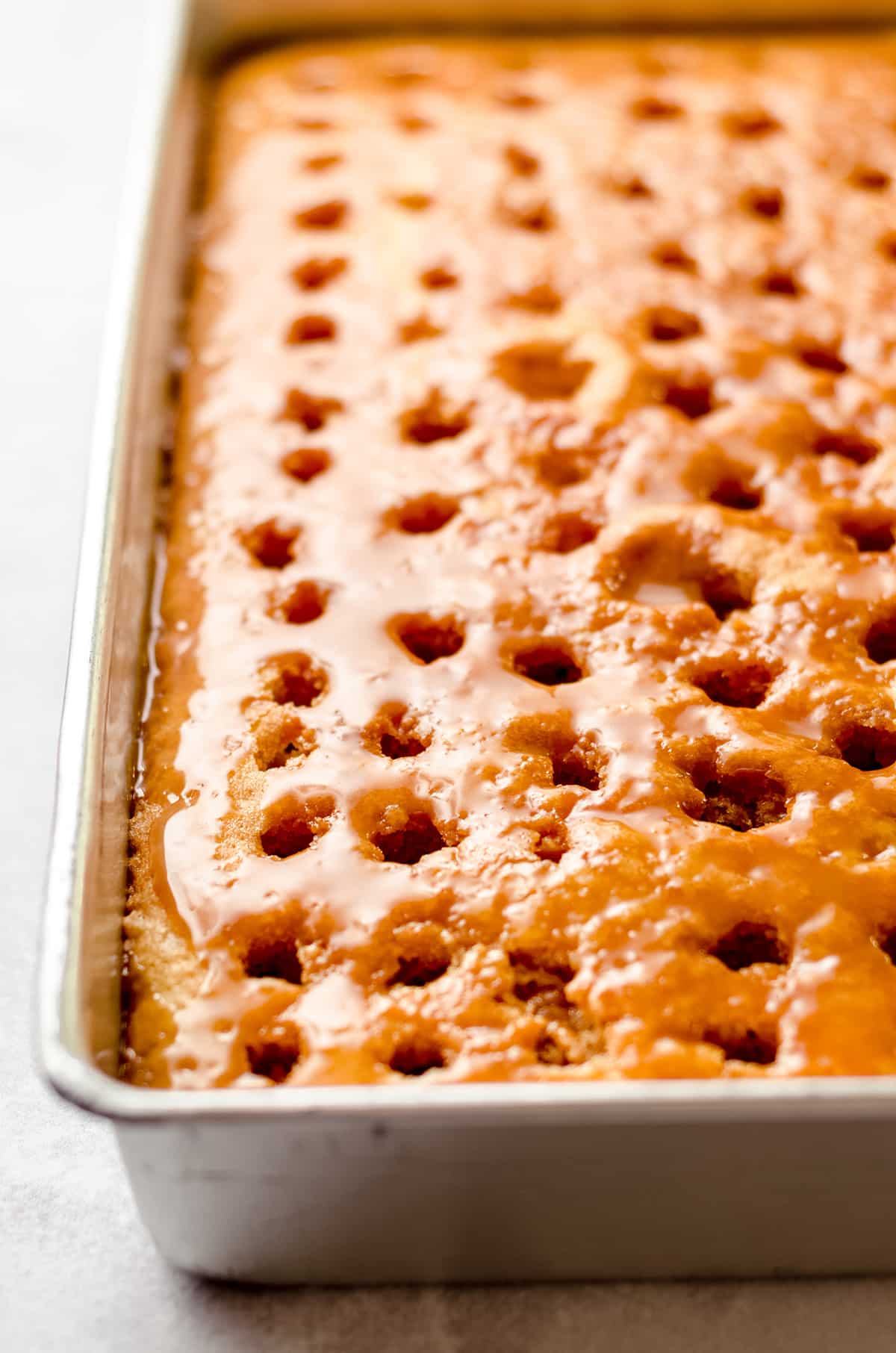 A poke cake with its sauce almost soaked in.