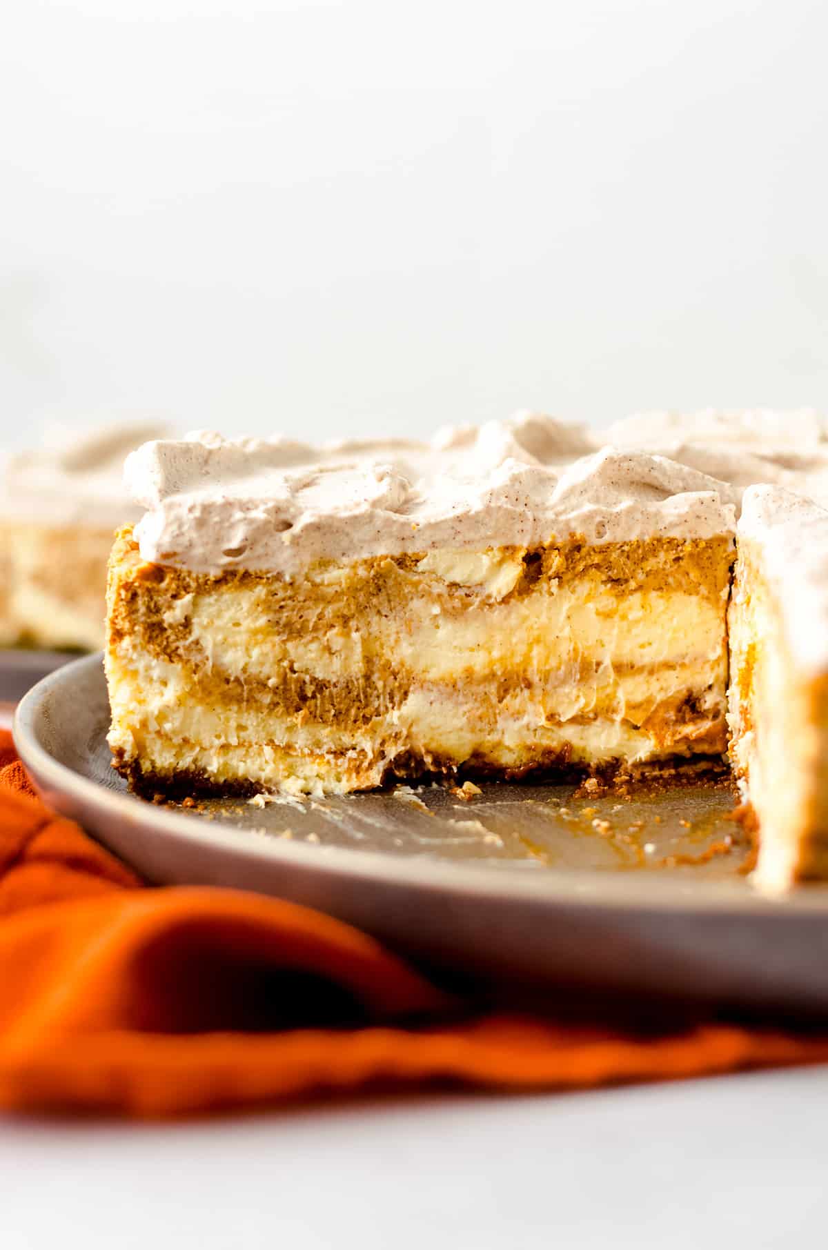A side view of a large pumpkin swirl cheesecake.
