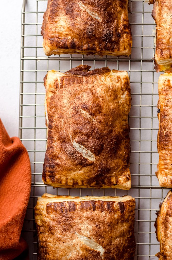 Several hand pies on a wire rack.