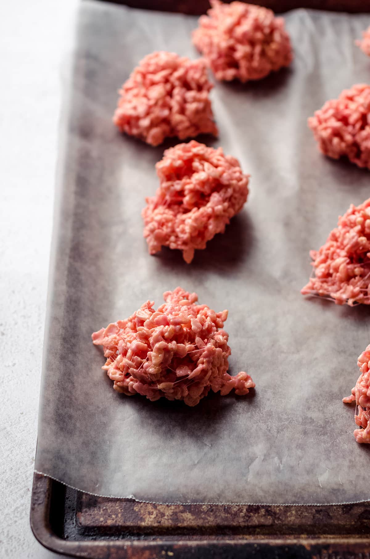mounds of pink rice krispies treats on baking sheet to make brains
