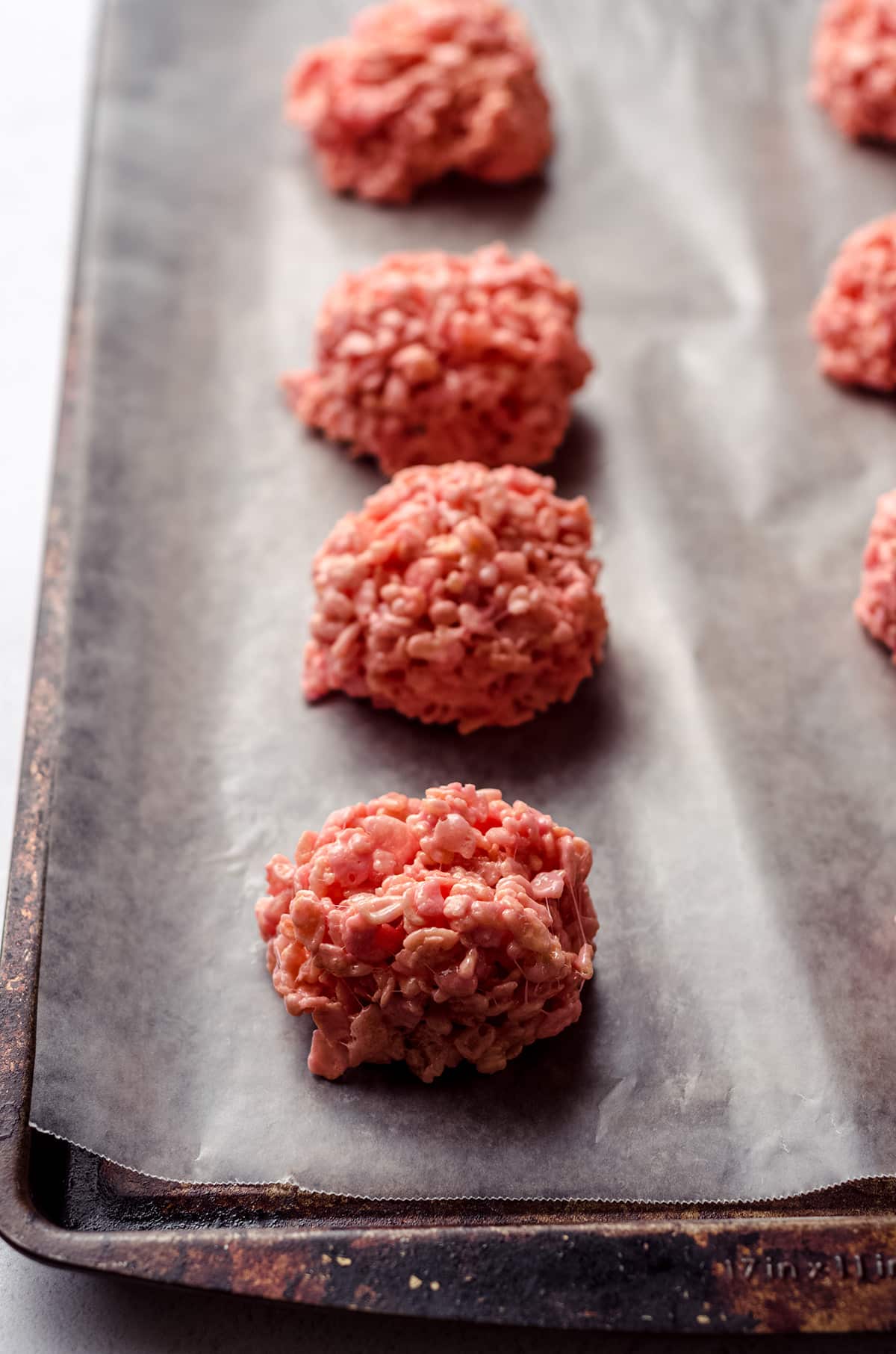 mounds of pink rice krispies treats on baking sheet to make brains