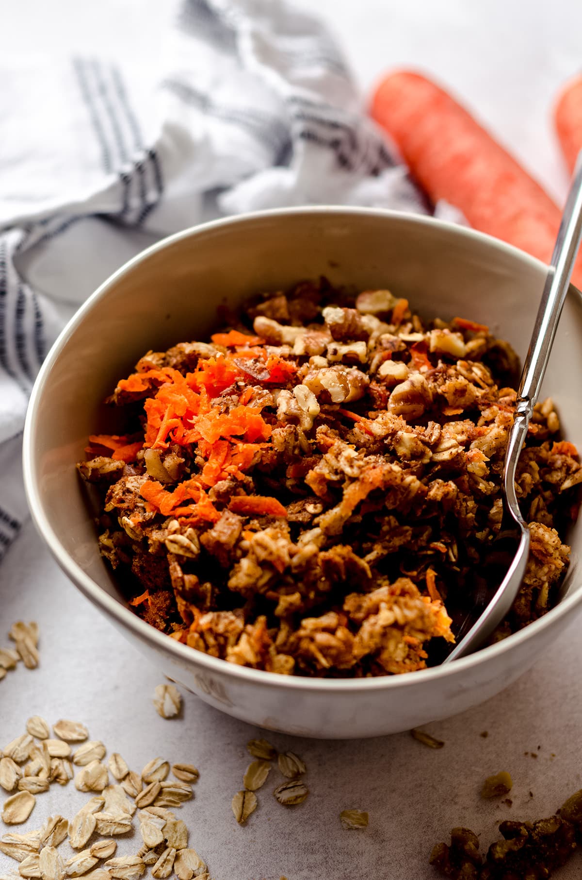 carrot cake baked oatmeal in a bowl with a spoon