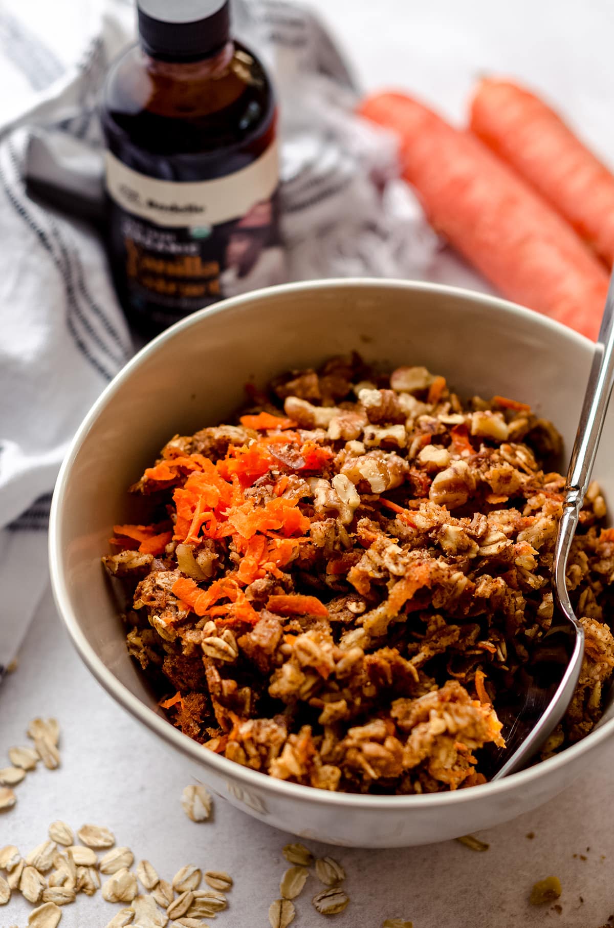 carrot cake baked oatmeal in a bowl with a spoon