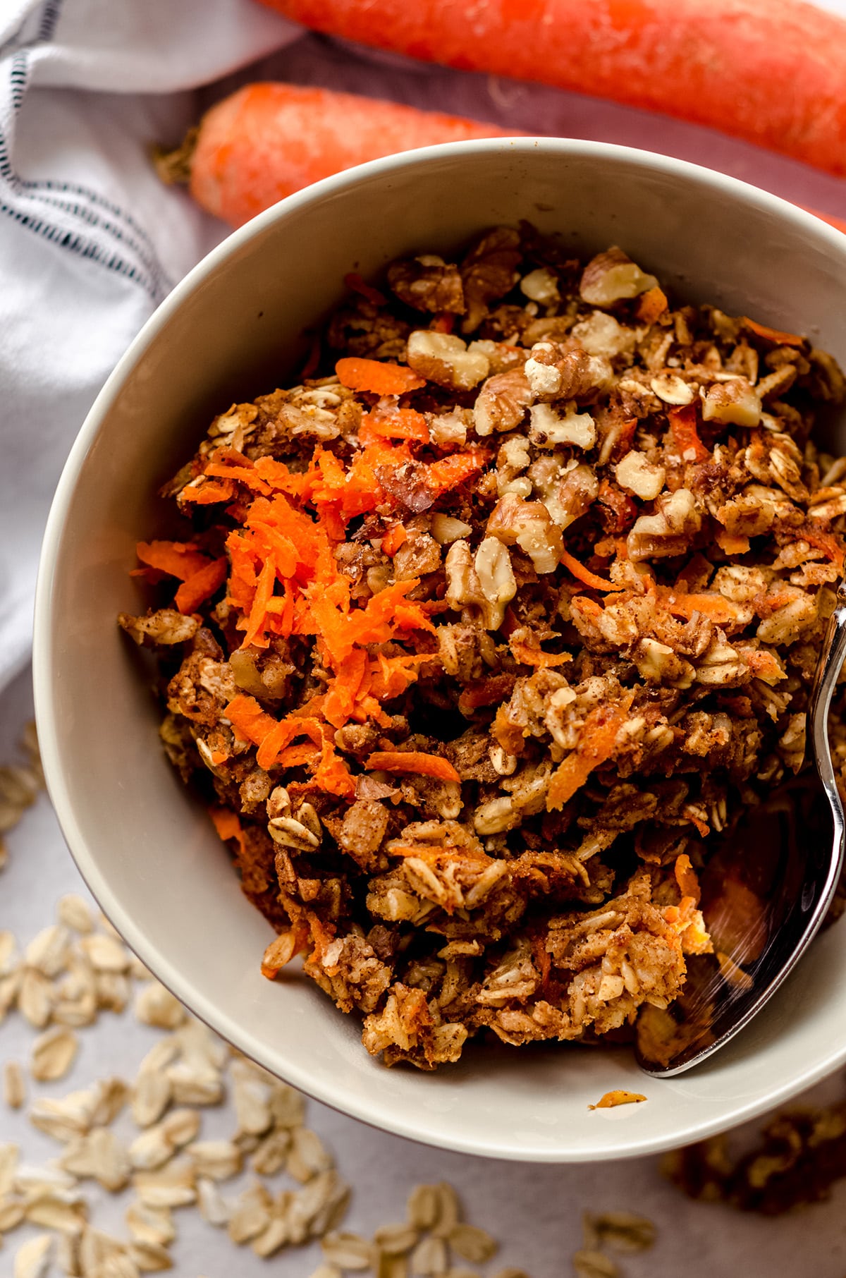 carrot cake baked oatmeal in a bowl with a spoon