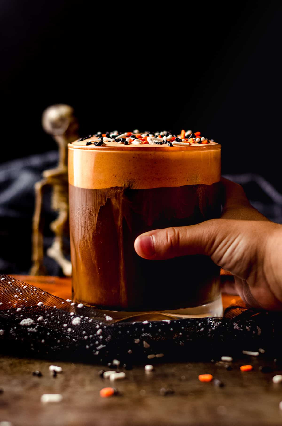 a child's hand around a cup of cold witches brew coffee (disney copycat)
