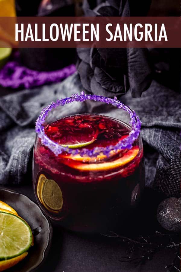 This spooky Halloween sangria is made with seasonal fruit, garnished with a colorful sugar rim, and is the perfect addition to your Halloween party spread. via @frshaprilflours