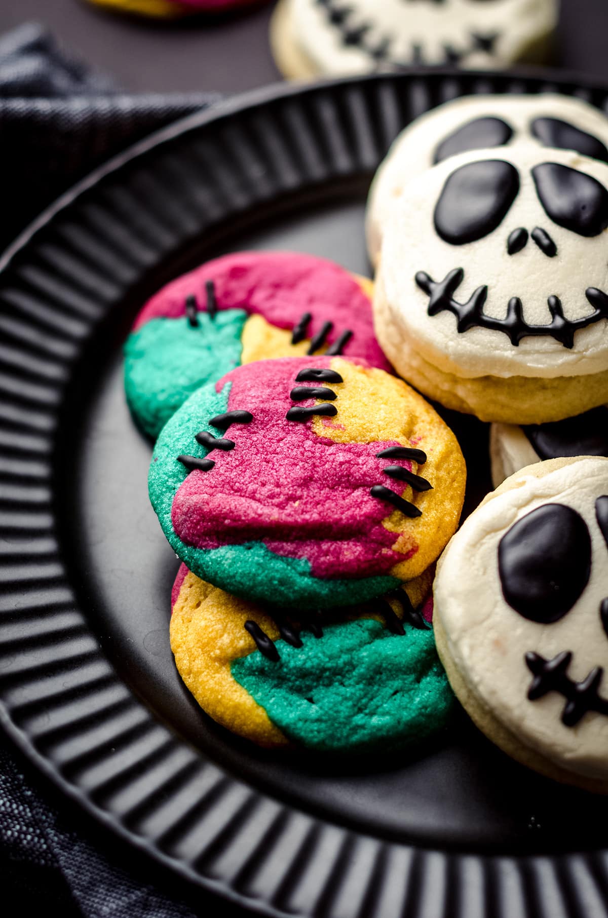 sally stitches sugar cookies on a plate with jack skellington cookies