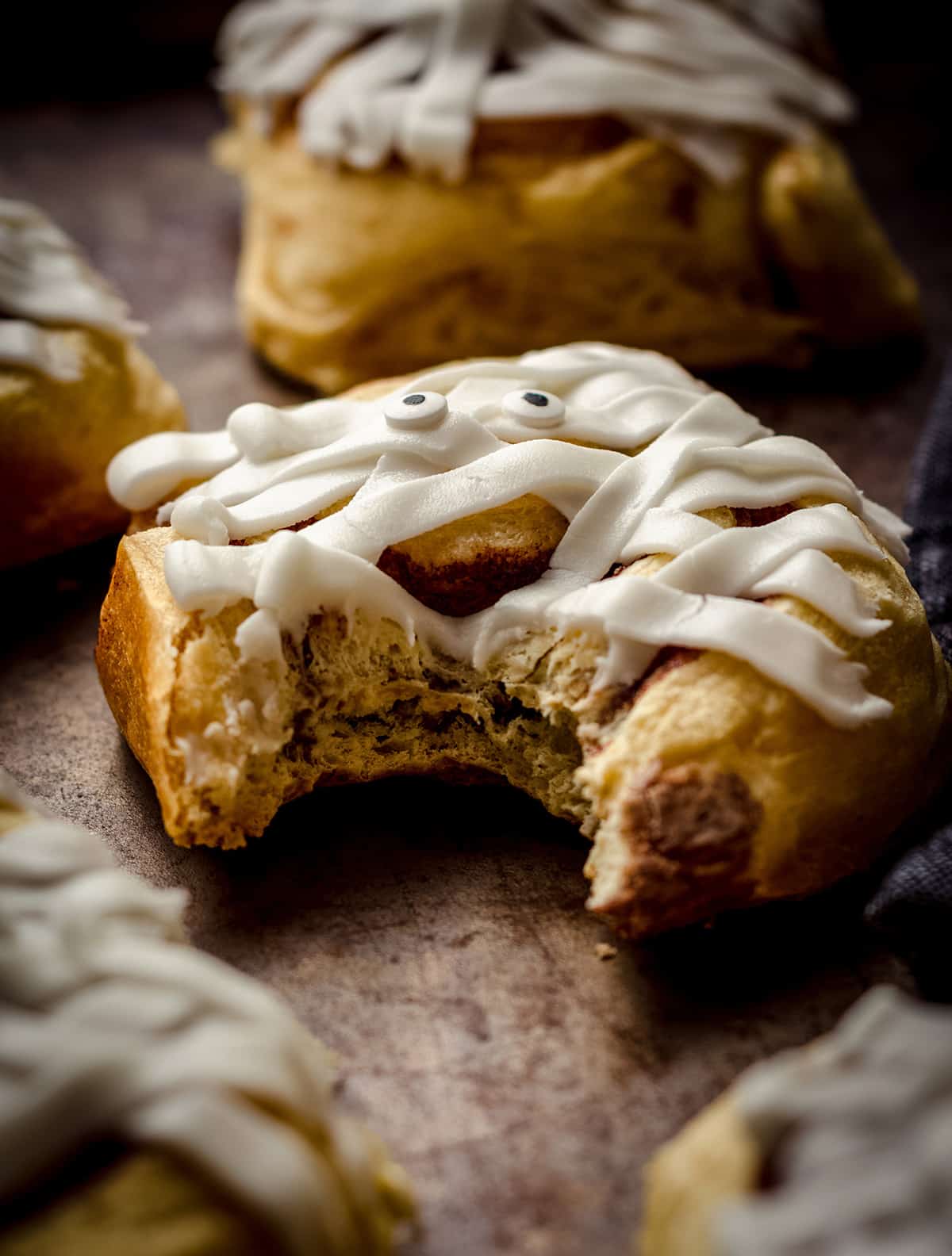 mummy cinnamon roll with a bite taken out of it