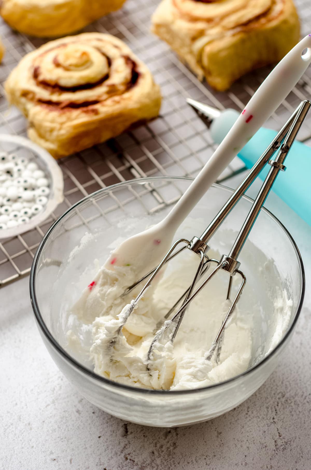 icing in a bowl with electric beaters