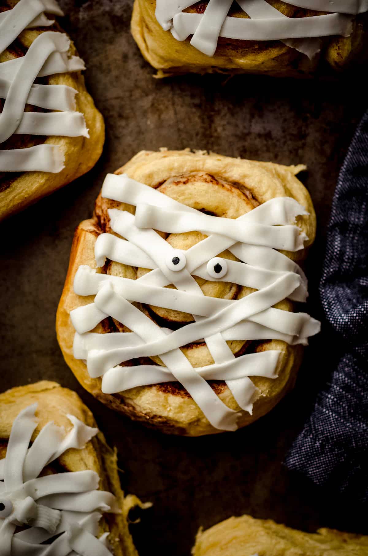 aerial photo of cinnamon roll mummies on a baking sheet