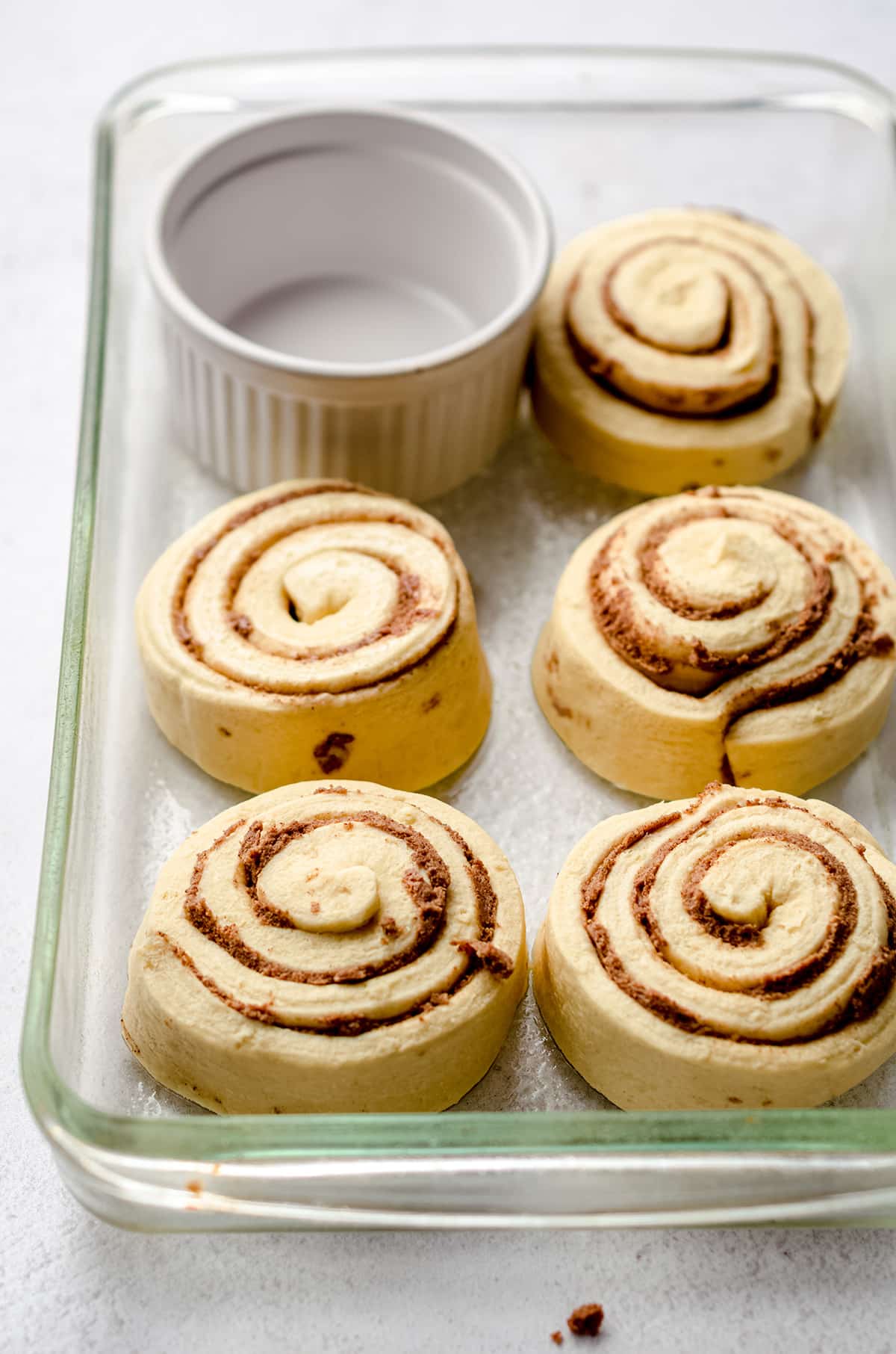 cinnamon rolls in a baking dish ready to bake