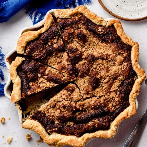 An overhead view of a molasses filled pie, topped with crumbs.
