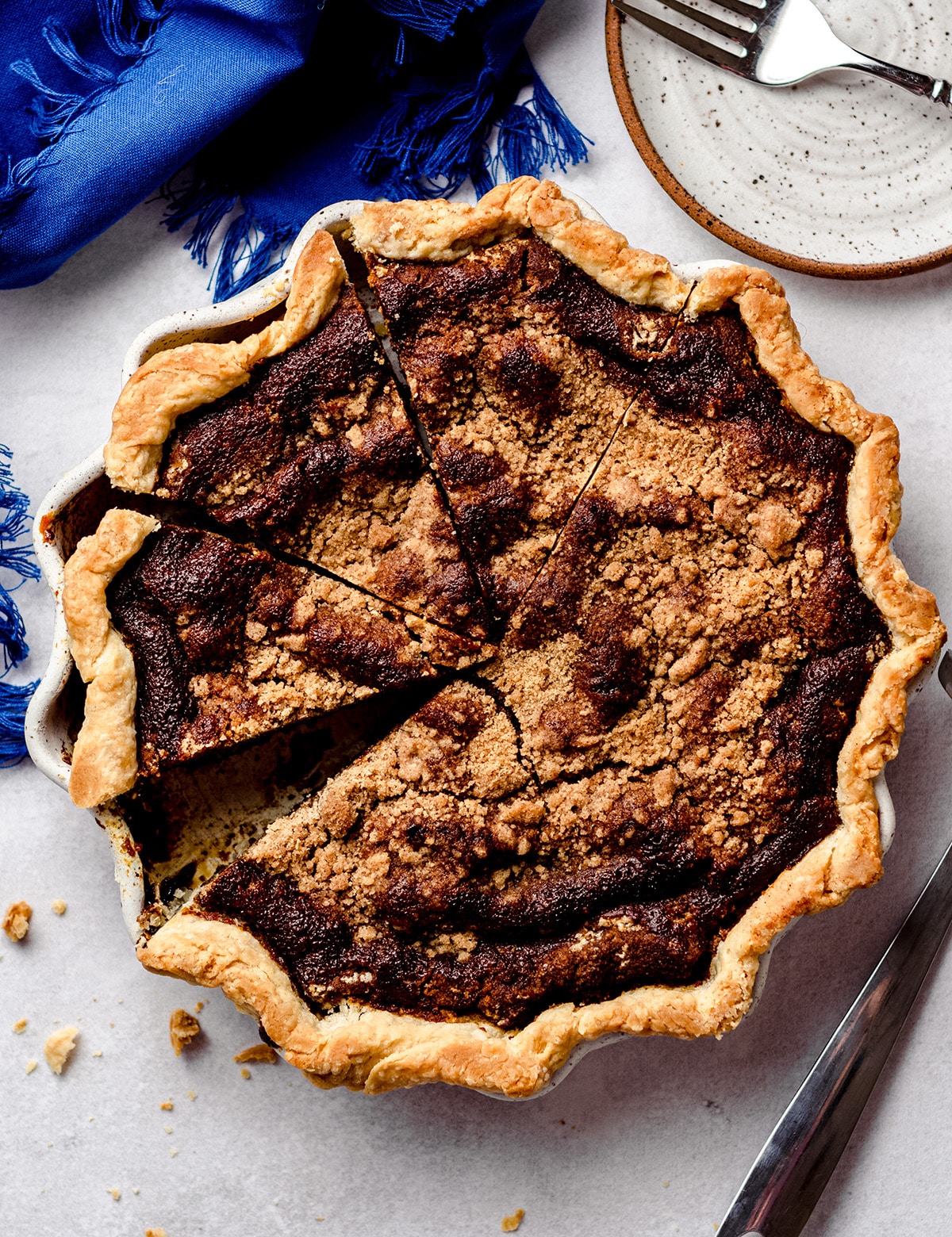 An overhead view of a molasses filled pie, topped with crumbs.