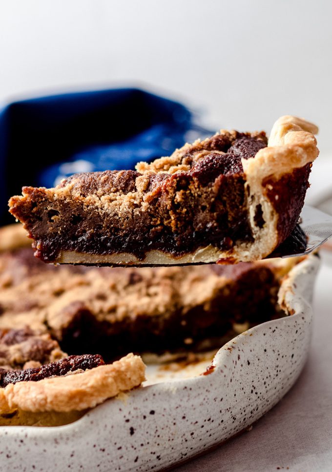 Lifting a slice of pie from a pie plate.