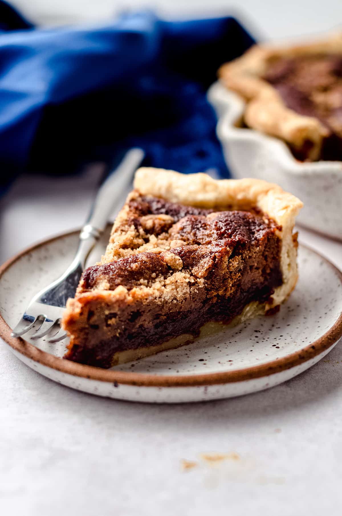 A slice of molasses filled pie with a fork.