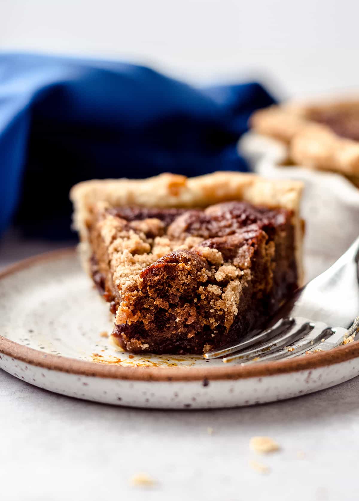 A piece of pie with a forkful taken out.