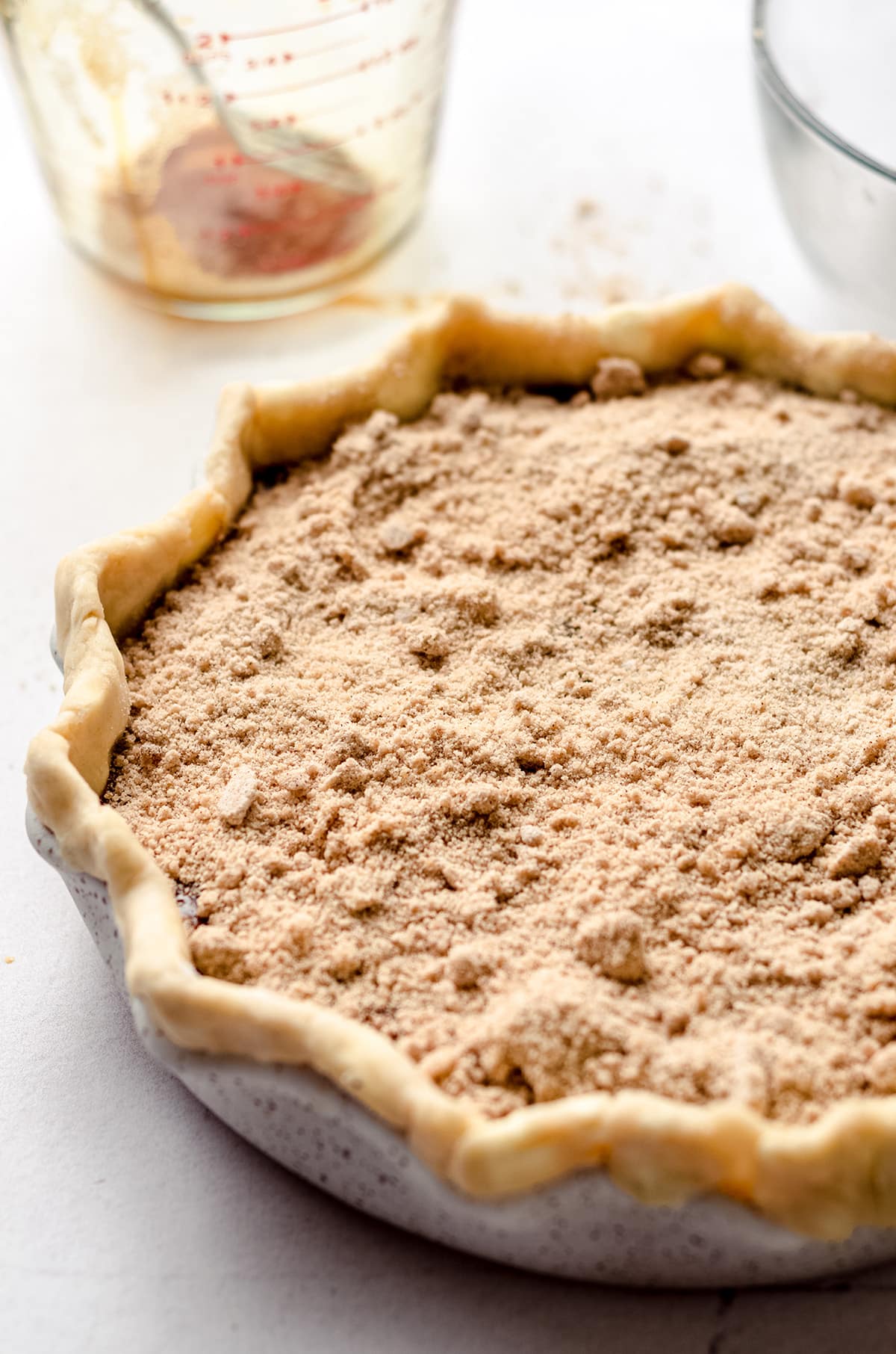 A pie topped with a crumb mixture.