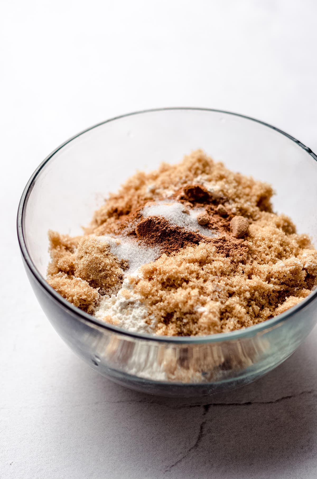 A small bowl filled with ingredients to make a crumb topping for pie.