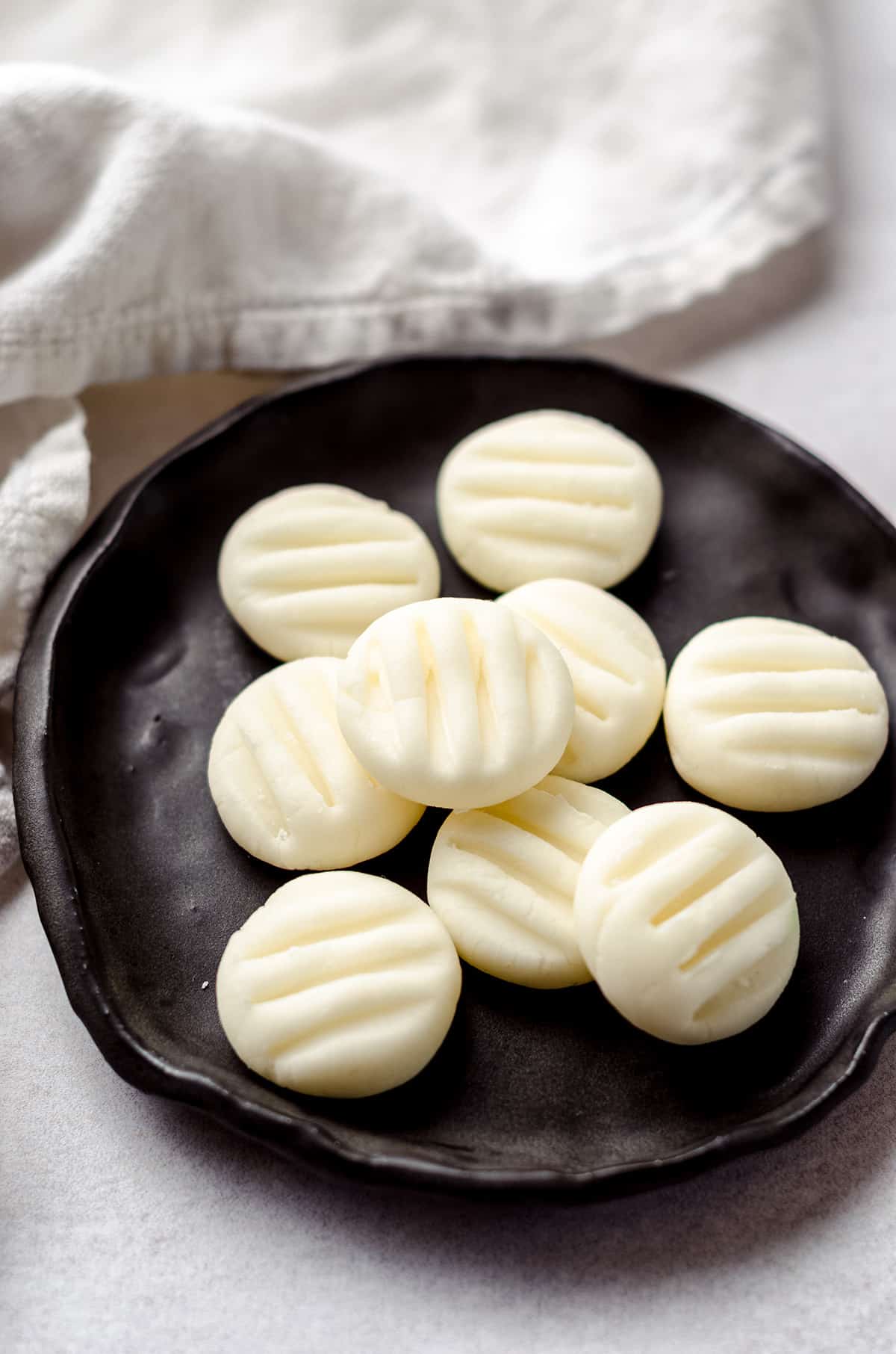 A plate of white cream cheese mints.