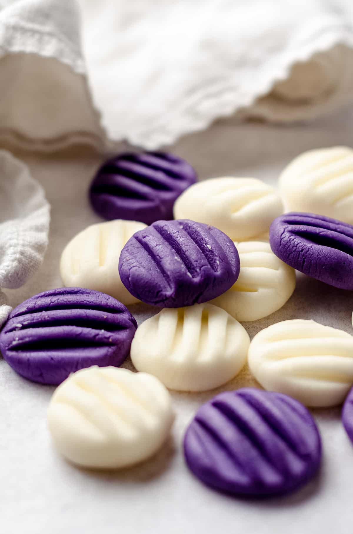 A scattering of purple and white homemade mint candies.