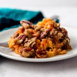 A plate with a serving of sweet potato casserole.