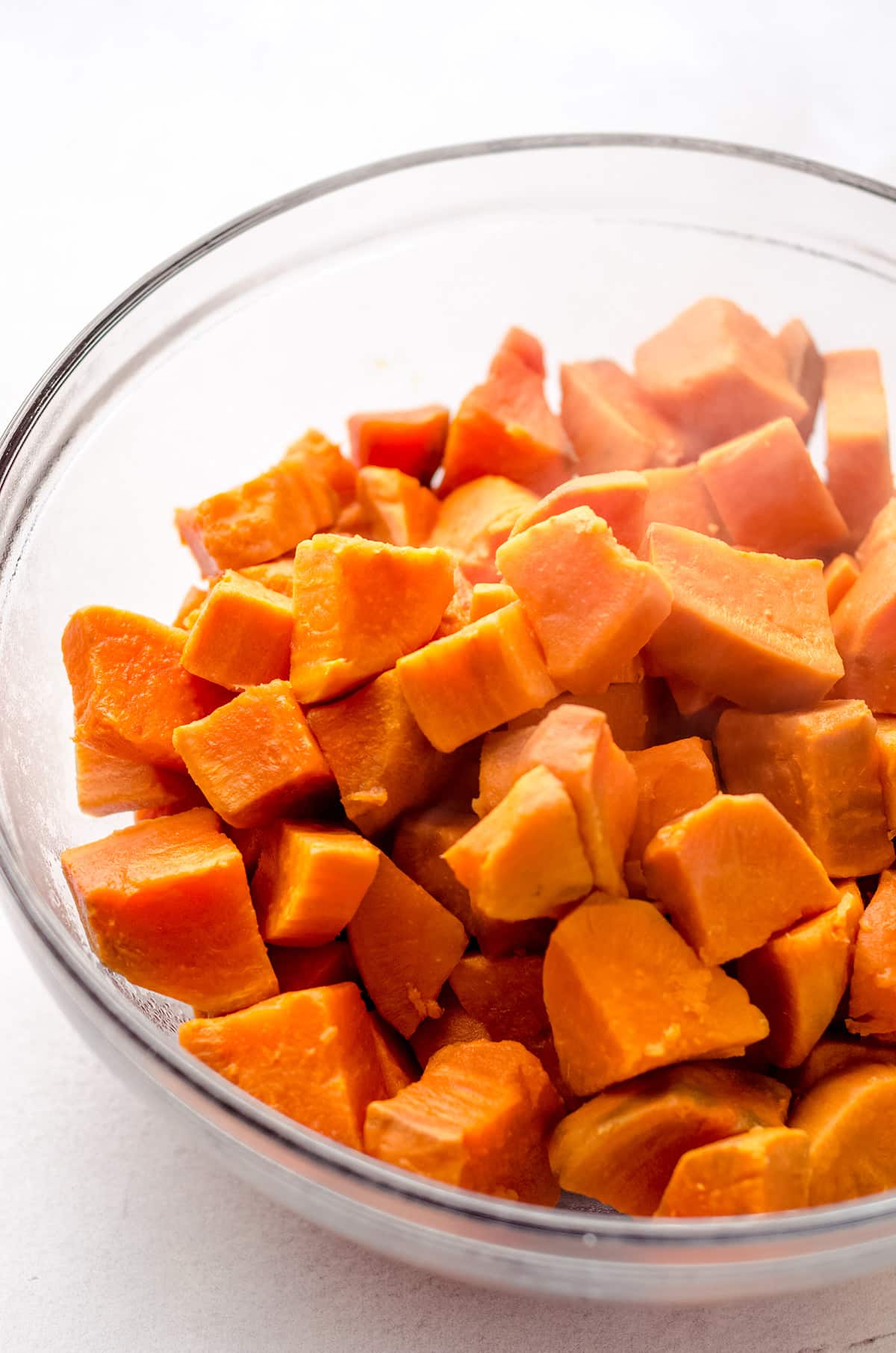 A bowl of cooked sweet potato cubes.