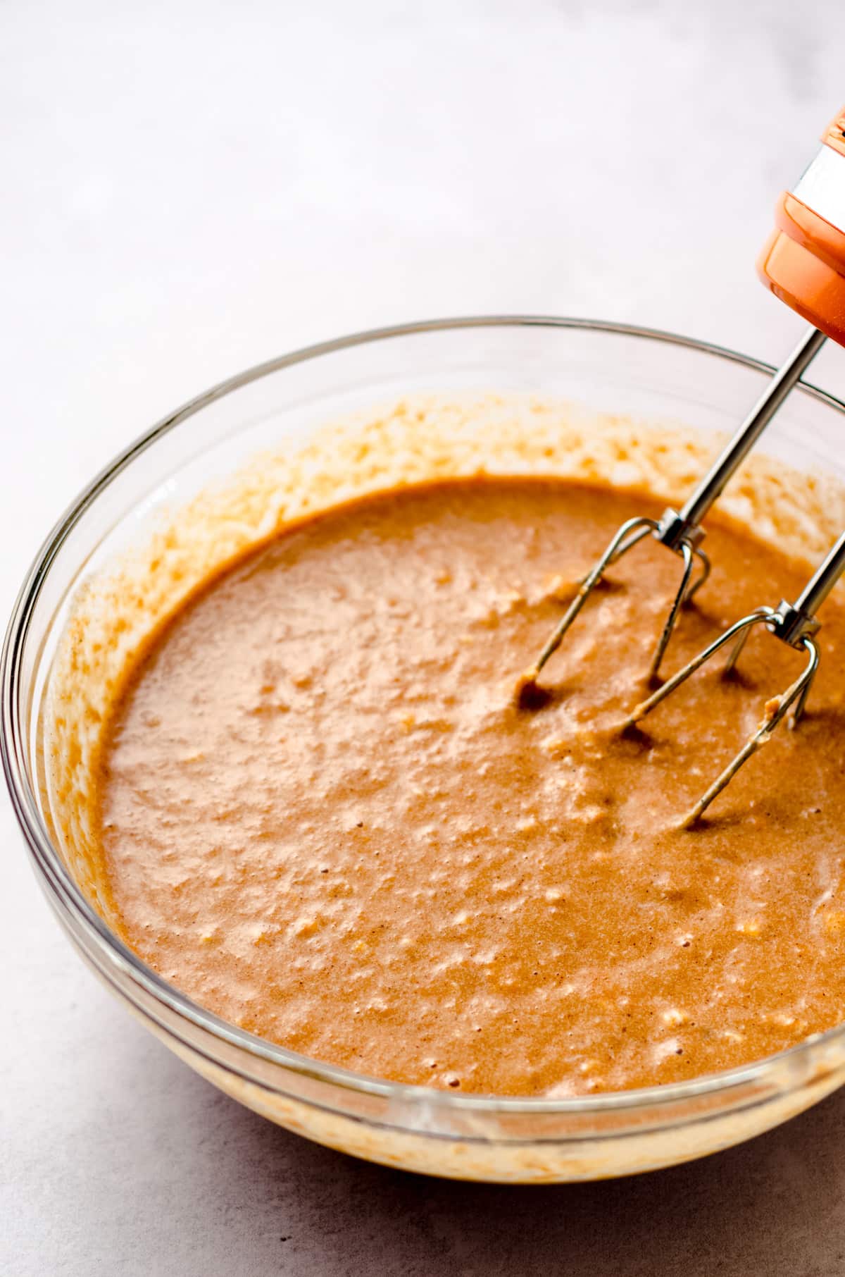 A bowl with sweet potato pie filling mixed up and ready to pour into a pie shell.