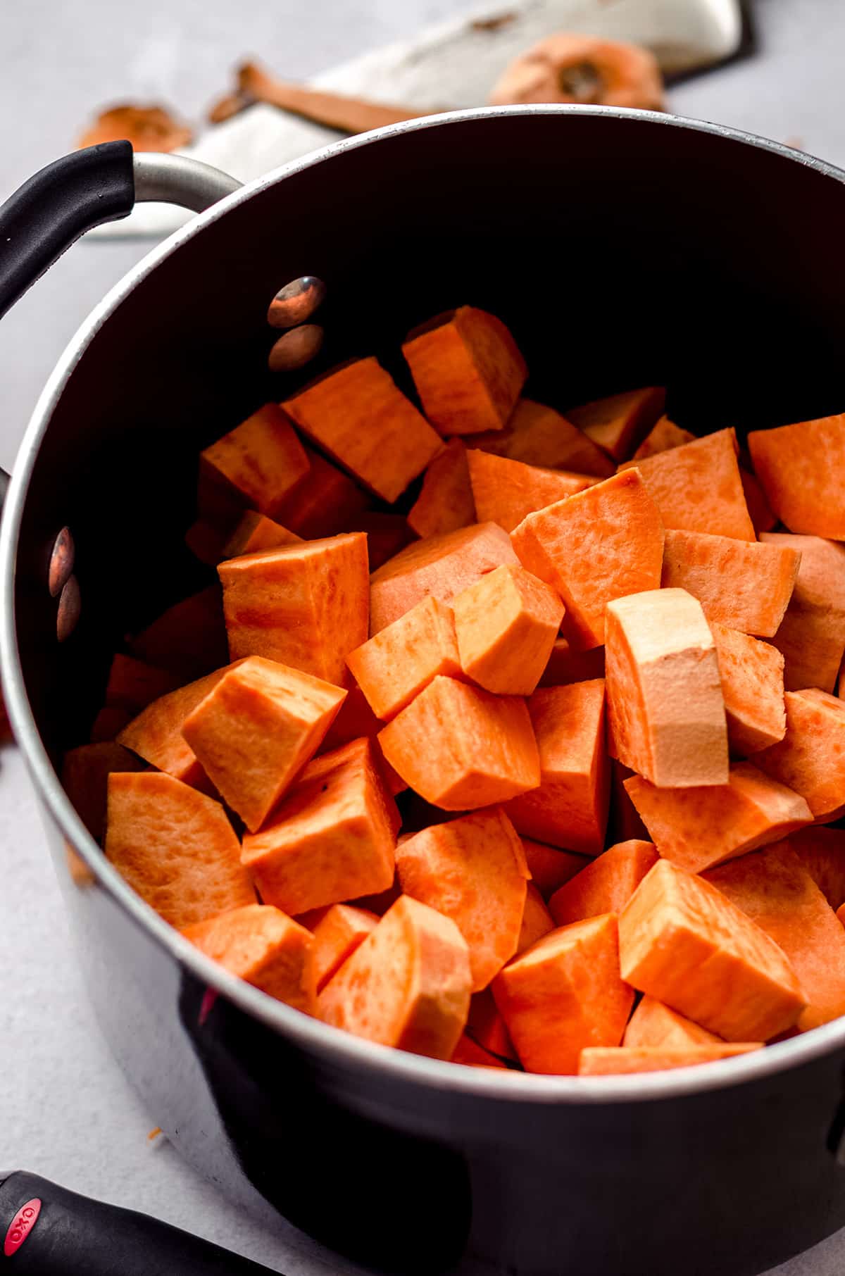 A saucepan filled with sweet potato chunks.