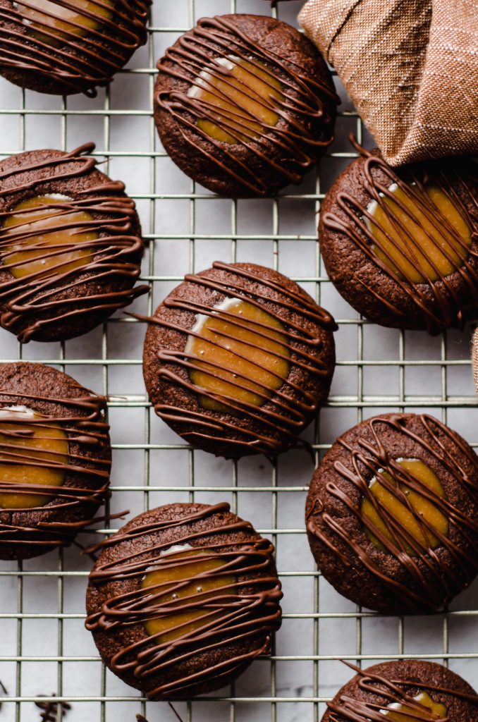 aerial photo of salted caramel chocolate thumbprint cookies on a cooling rack