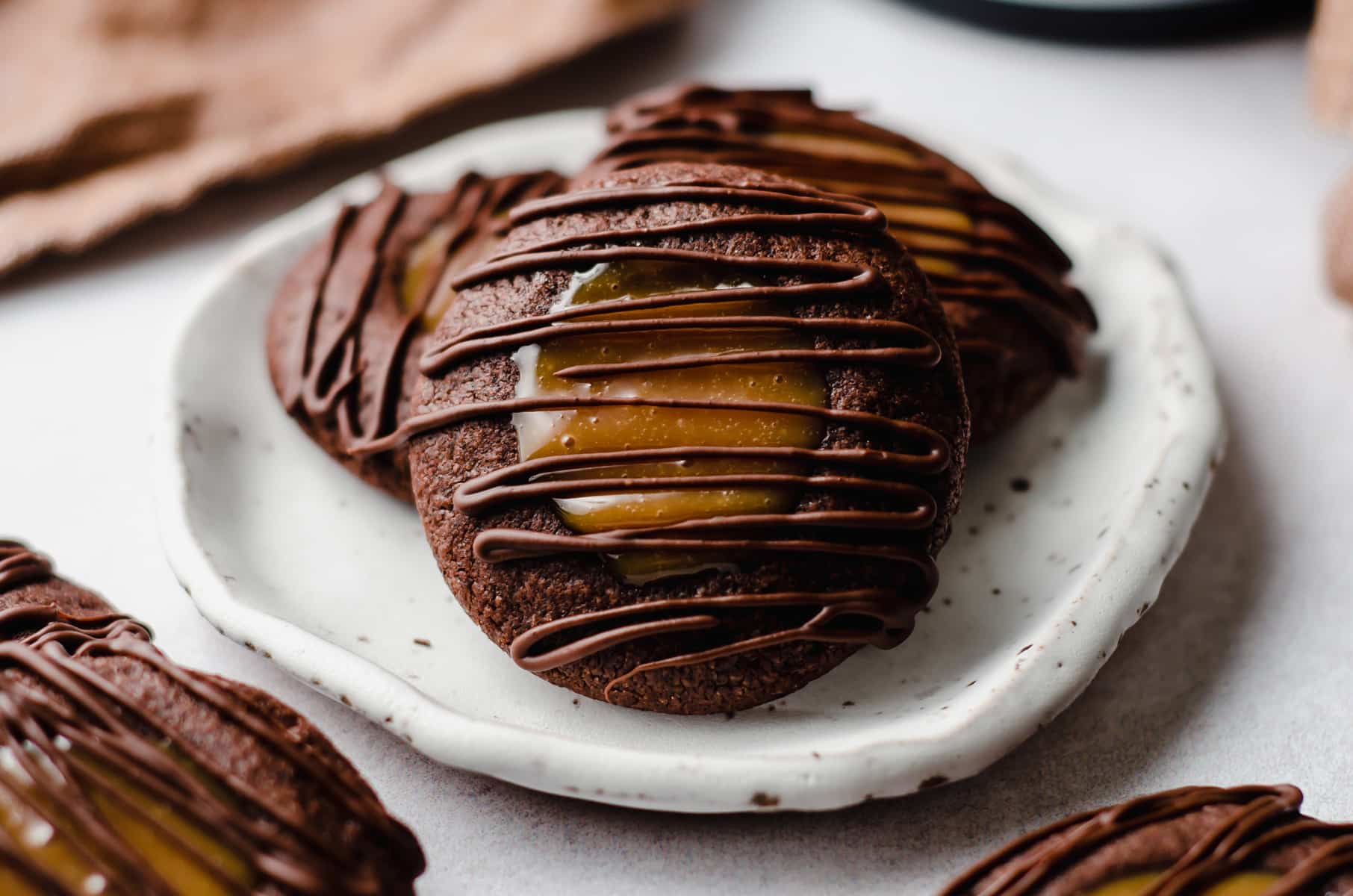 chocolate caramel thumbprint cookies on a plate