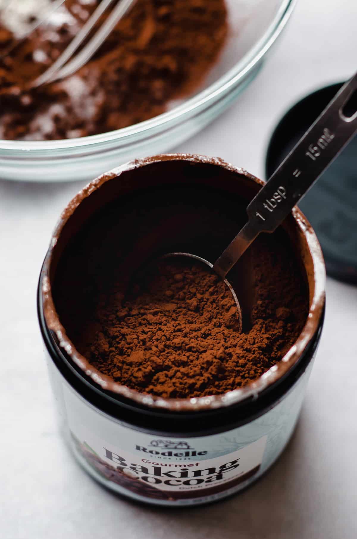 canister of rodelle dutch processed cocoa powder with a measuring spoon in it