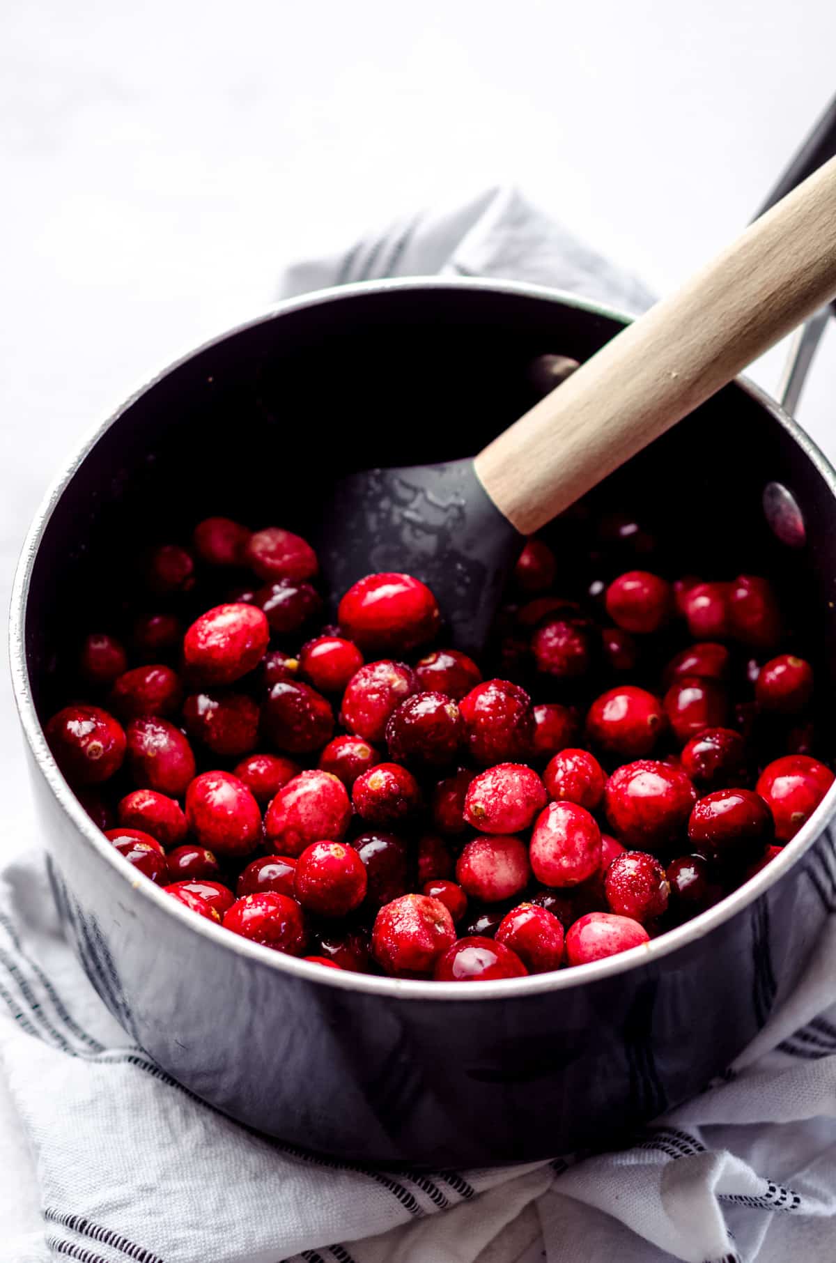 a saucepan full of cranberries and sugar ready to make cranberry curd