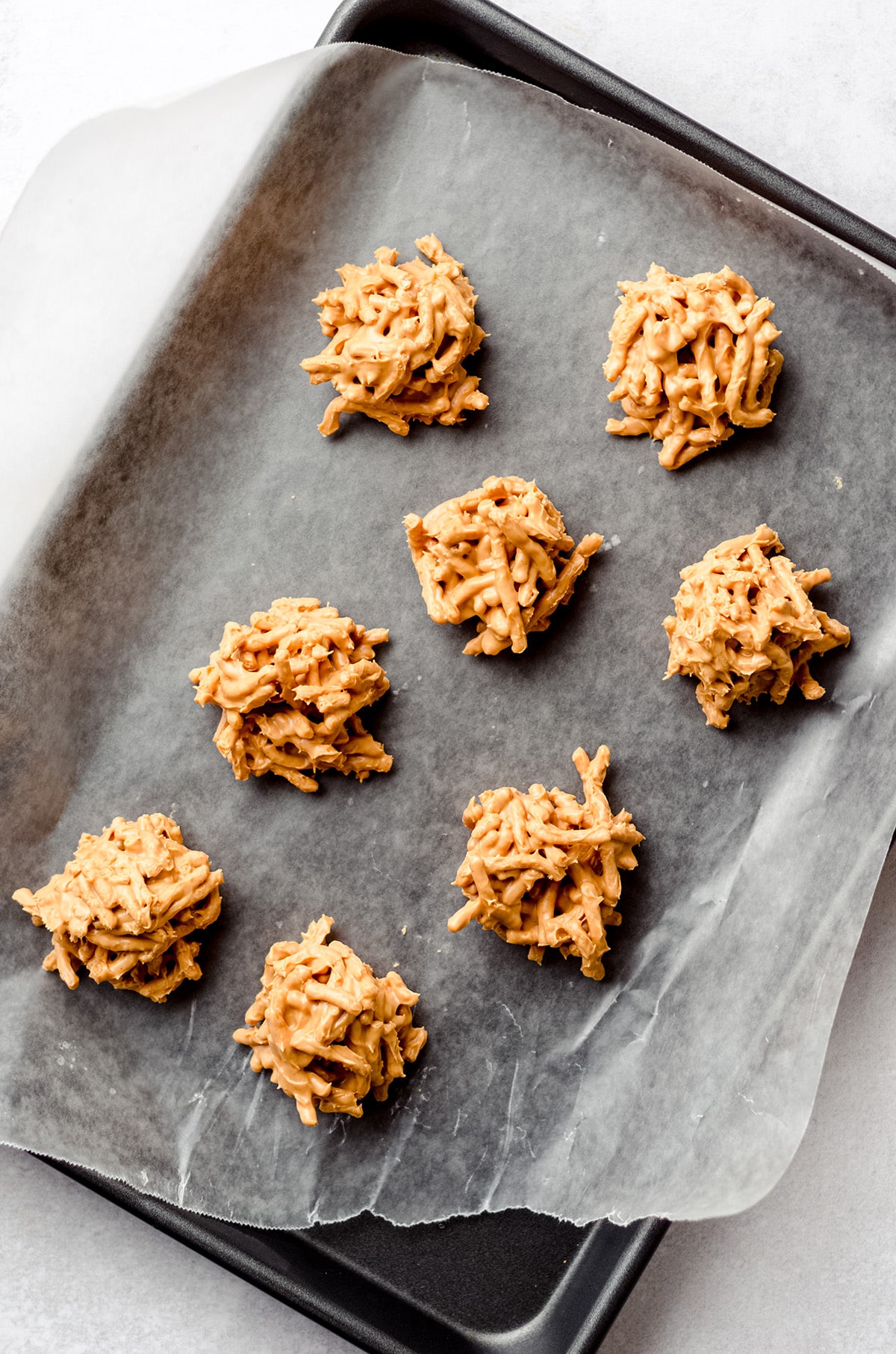 A baking sheet with butterscotch no bake cookies.