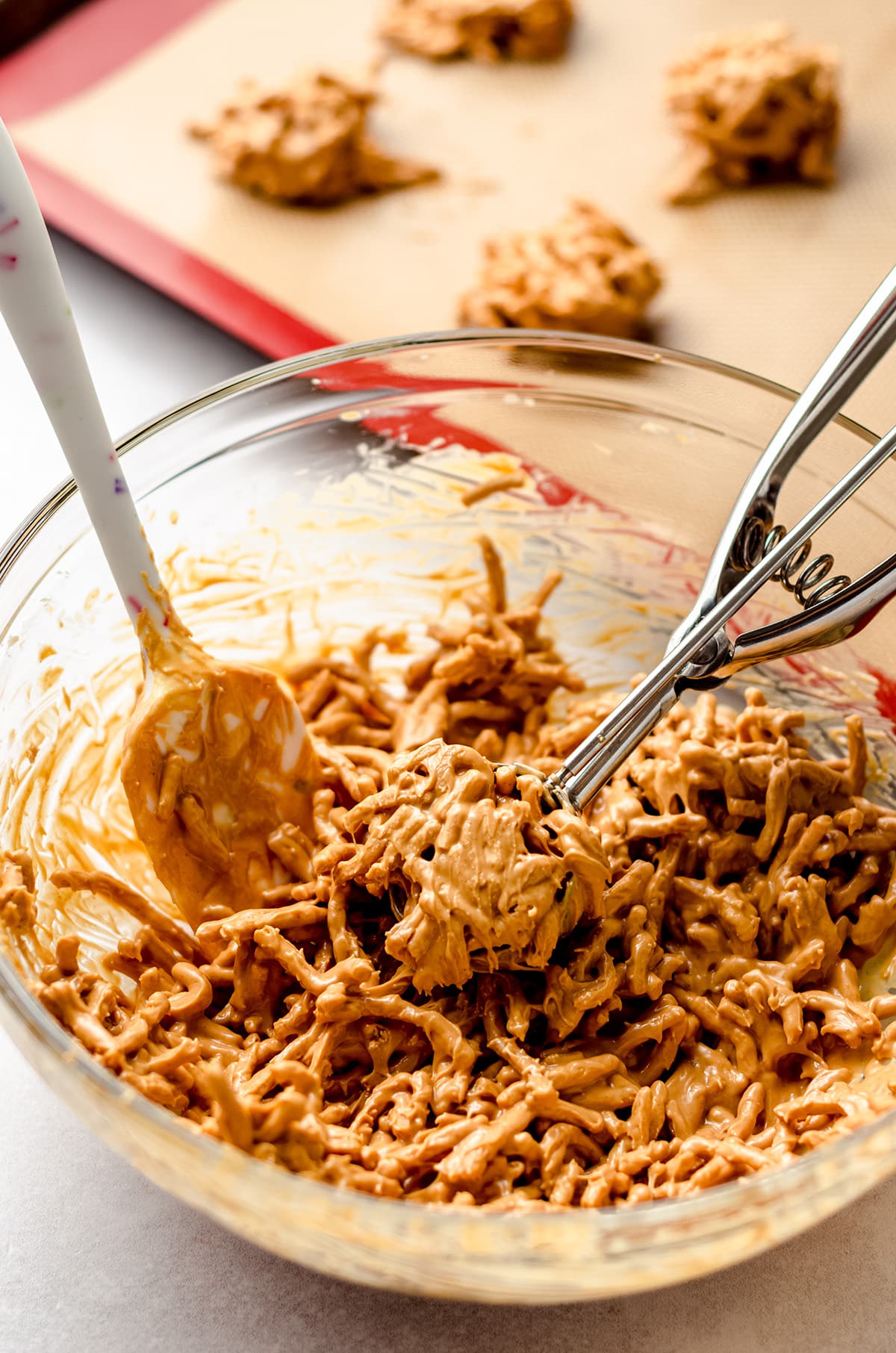 Using a cookie scoop to portion out haystack batter.