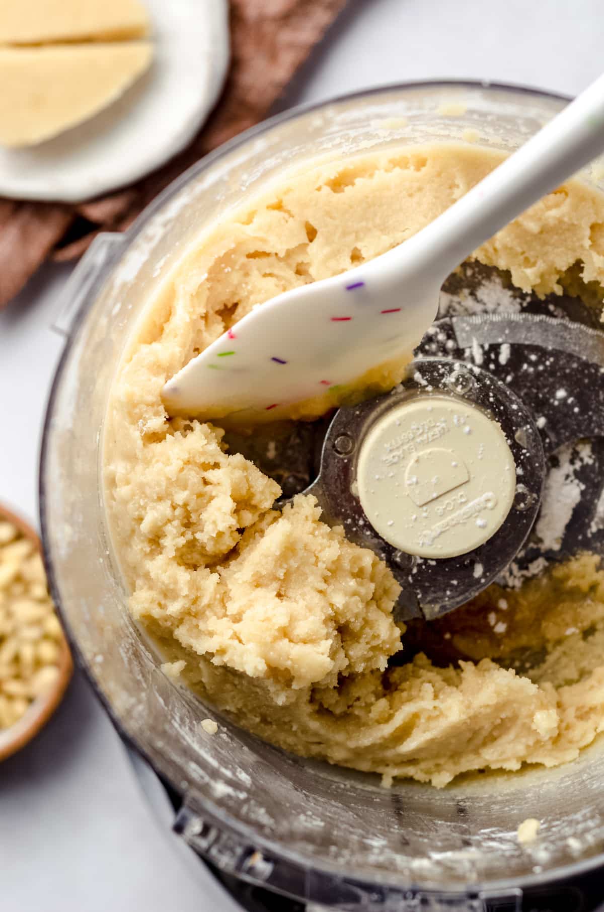 Scraping down the sides of food processor with cookie dough.