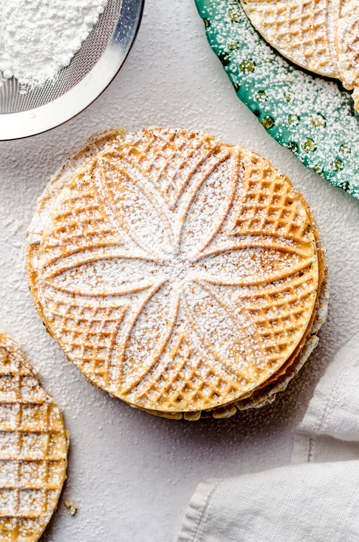 An overhead view of a stack of pizzelle cookies.