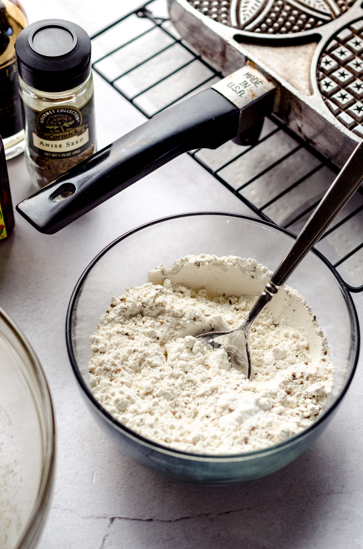 A small bowl of dry ingredients with anise seed.