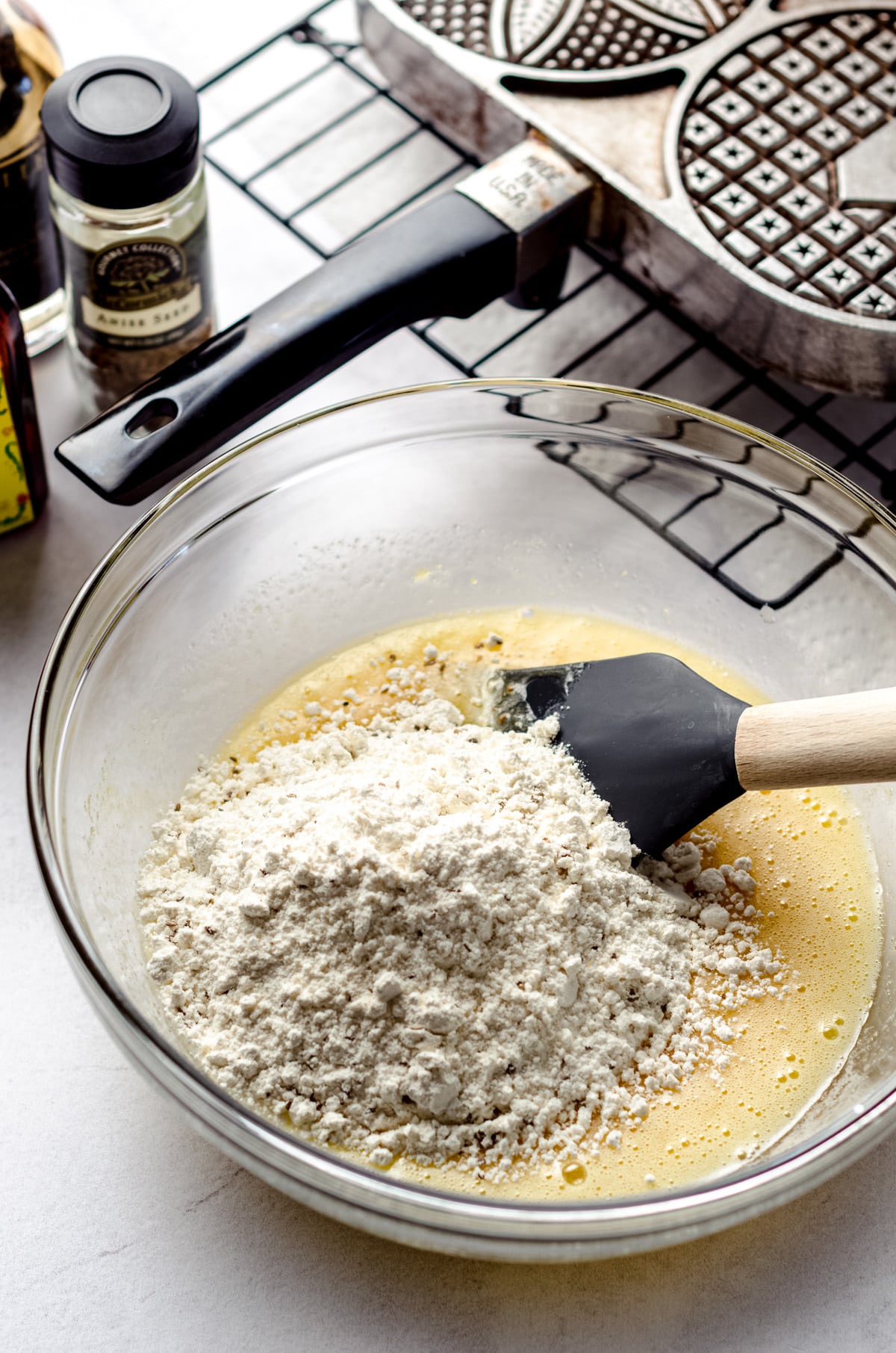 Adding flour into wet ingredients.