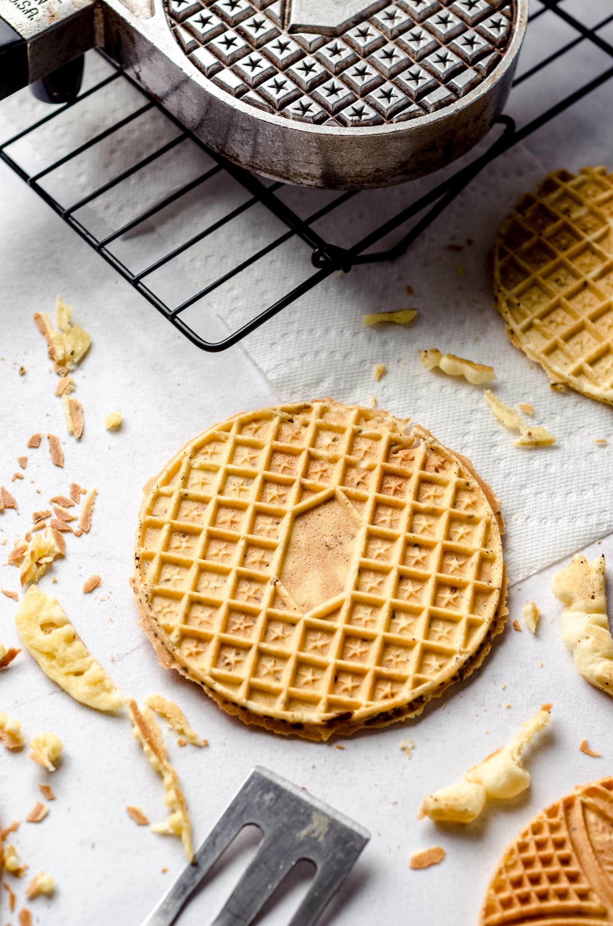 Trimming the edges of a pizzelle.