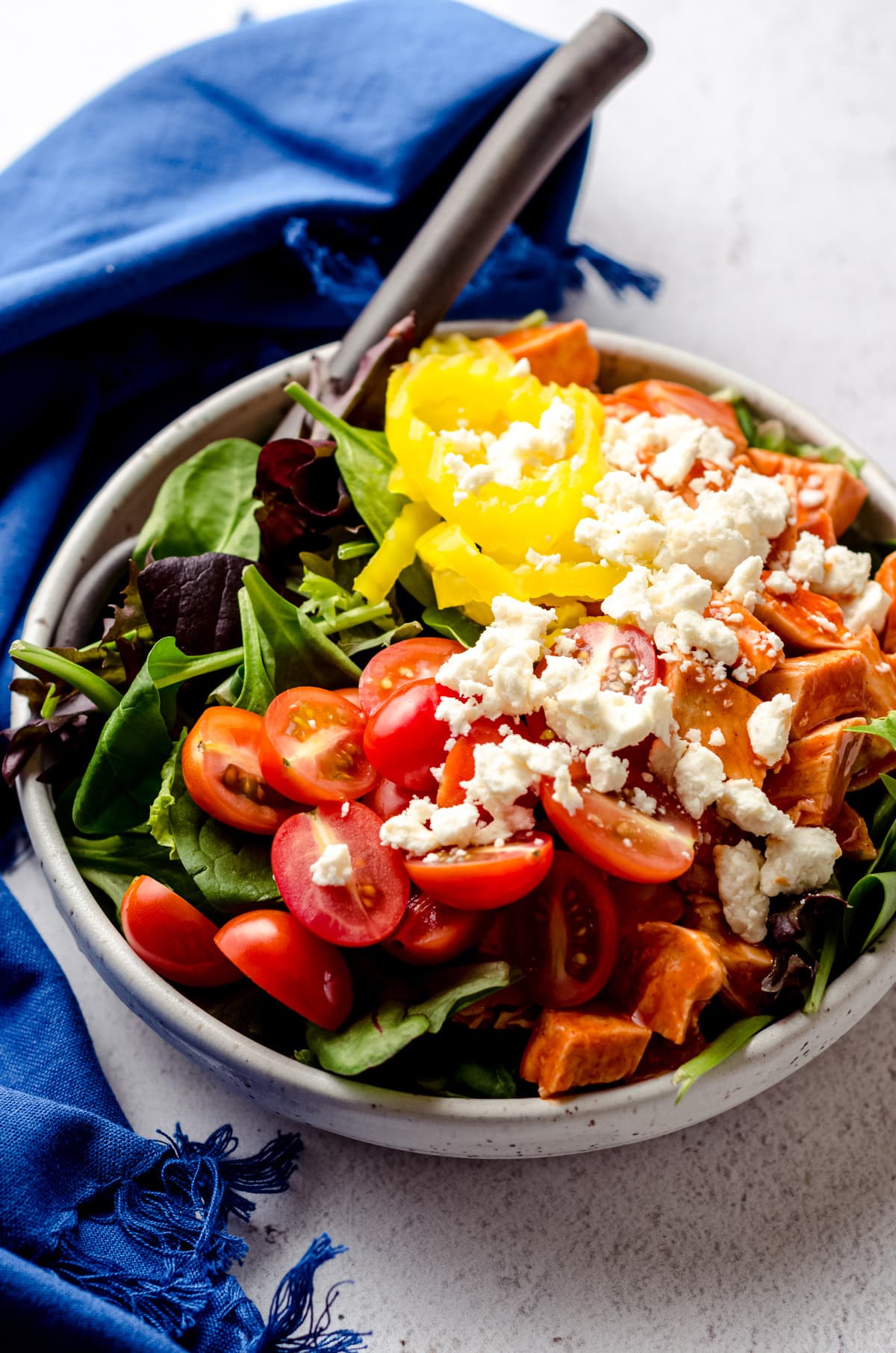 Buffalo blue salad prepared in a bowl with a large serving spoon.