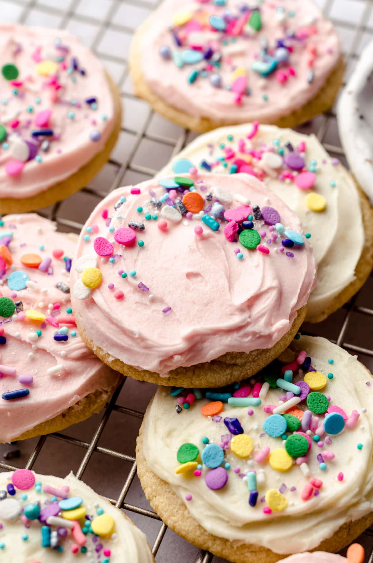 frosted sugar cookies on a cooling rack