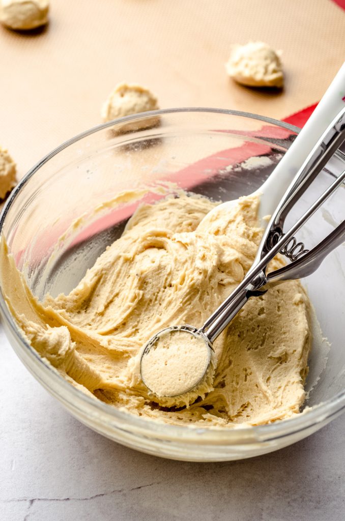 sugar cookie dough in a bowl with a cookie scoop