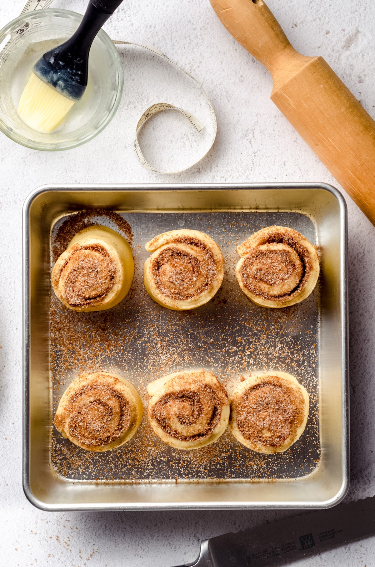 Small batch cinnamon rolls in a baking dish ready to rise.