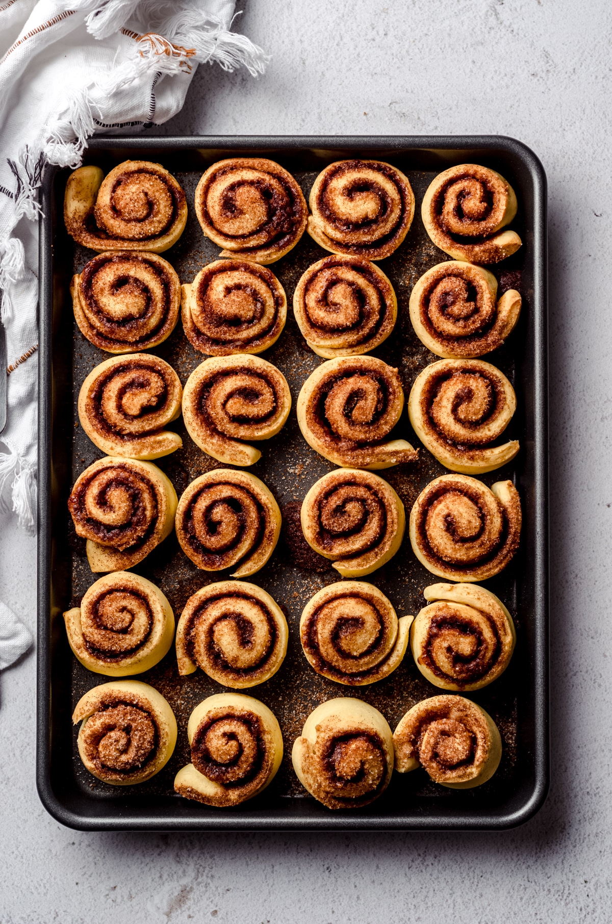 Aerial photo of mini cinnamon rolls baked in a baking pan.