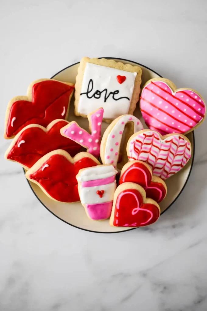 An aerial photo of a plate of sourdough sugar cookies decorated for Valentine's Day.