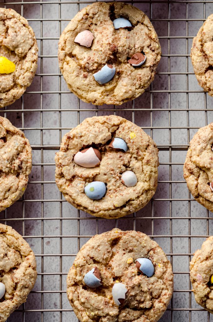 Aerial photo of mini egg cookies on a wire cooling rack.