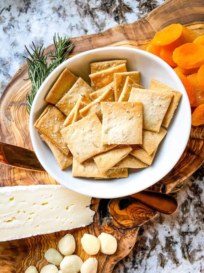 An aerial photo of rosemary sourdough crackers in a bowl.