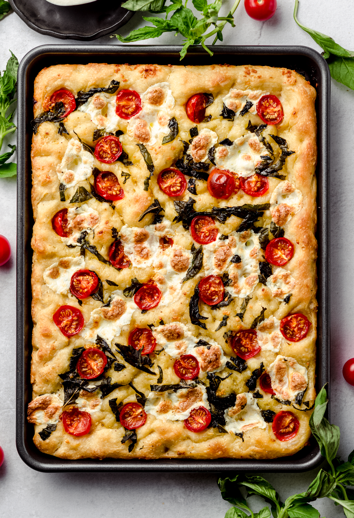 Aerial photo of caprese focaccia in a baking sheet.